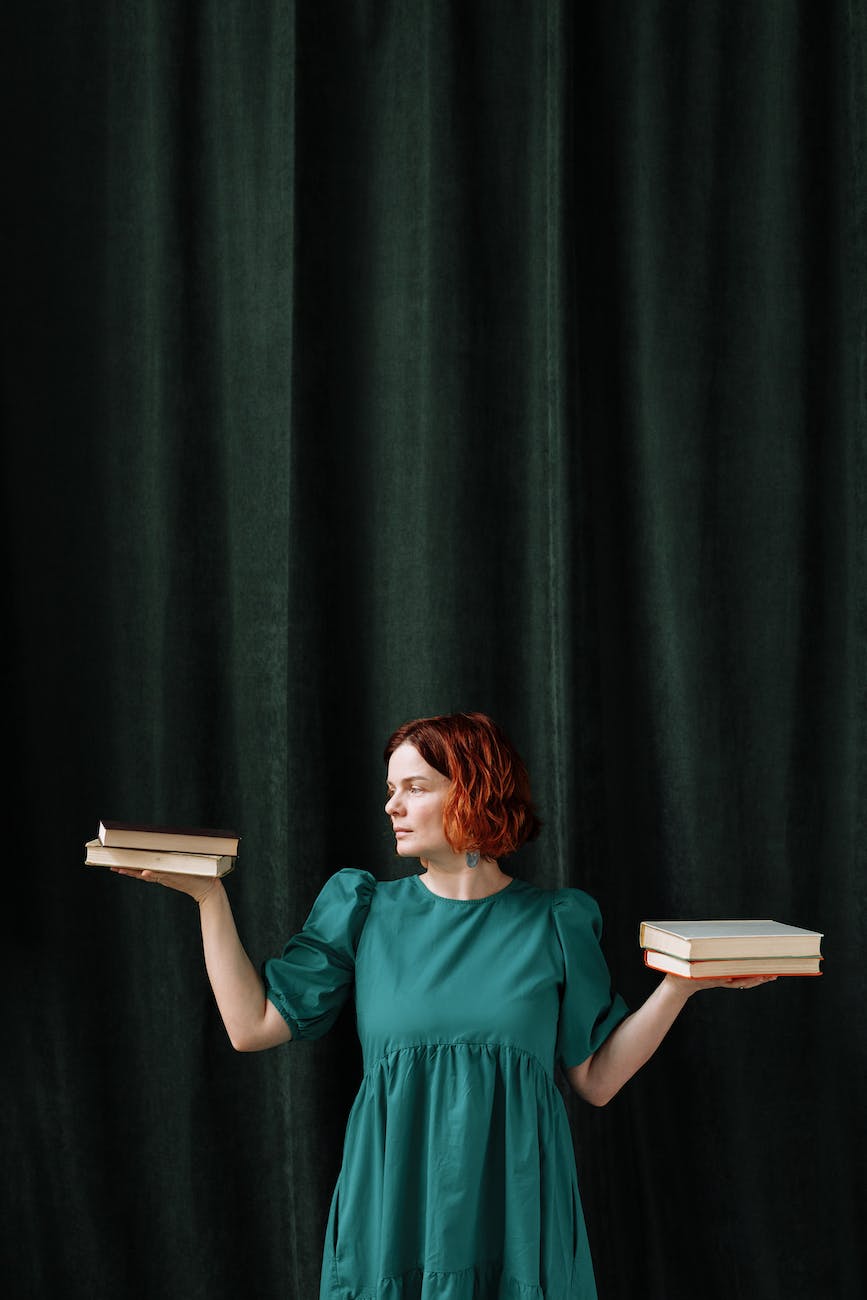 a woman weighing stacks of books